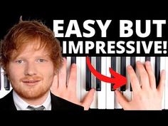 a man in a suit and tie with his hands on the keys of a piano