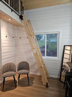 two chairs and a ladder in a room