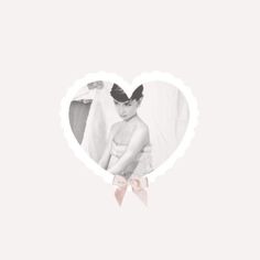 a heart shaped photo with a pink bow on it's head and the image of a woman in a white dress