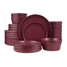 a stack of purple dinnerware on a white background