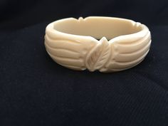 "Rare Art Deco vintage carved Galalith bangle bracelet ~ also called French Bakelite. Superb deeply carved leaf design ~ a beautiful tactile design. The color is a lovely warm ivory. The piece is circa 1930's or 1940s and is French in origin. Galalith or Casein which is the generic name is a registered trade mark, patented in the 1890's in Bavaria. It was first produced by the International Galalith Gesseschaft Hoff & Co. for the Paris Universal Exhibition of 1900., Galalith is made from ski Antique Carved Bracelets, Elegant Bakelite Bangle As Gift, Art Deco Bangle Bracelets Collectible, Elegant Bakelite Bangle As A Gift, Vintage Intaglio Bracelets For Formal Occasions, Vintage Handmade Cream Bracelets, Handmade Vintage Cream Bracelets, Vintage Carved Jewelry Bracelet, Vintage Carved Bracelet Jewelry