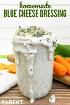 homemade blue cheese dressing in a jar with carrots and celery on the side