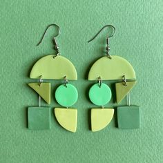 Modern geometric earrings in mismatched green / Bauhaus modern earrings / Lightweight polymer clay statement earrings Mini works of art for your ears. These earrings were truly a labor of love.  The whole process from start to finish was so satisfying: from sketching shape combinations, to color exploration, to the industrial design, to color matching with clay, to the creation, and assembly.  Available in 2 sizes: SMALL (modeled in the photo) - dangle/drop length with hook: 2.75" - earring dimensions: 1.25" W x 2" H LARGE (modeled in the video) - dangle/drop length with hook: 3.25" H - earring dimensions: 1.5" W x 2.25" H - 🤲🏽 SMALL BATCH FROM PHILADELPHIA, PA - My little joys are slow made, handmade, and therefore, small batch. Nothing mass-produced about it! You may notice slight impe Color Exploration, Block Colour, Polymer Crafts, So Satisfying, Modern Earrings, Geometric Earrings, Philadelphia Pa, Small Batch, Boho Earrings