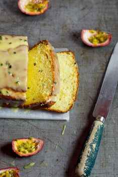 a loaf of lemon poppy seed pound cake on a cutting board with a knife next to it