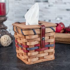 a wooden basket with tissue in it on a table