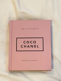 the little guide to coco chanel style to live by book sitting on a bed