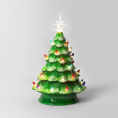 a small green christmas tree with lights on it's sides and a star above the top