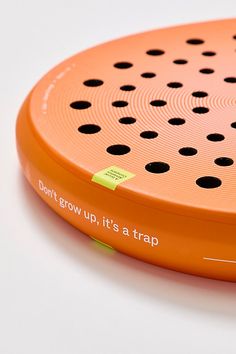 an orange frisbee sitting on top of a white table