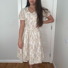 Nwt Beautiful Midi Dress, Very Fitted On The Top And Has A Nice Flare. For Reference Im Almost 5’4 And The Dress Is A Perfect Midi Dress (Below My Knees But Above My Ankles) Cream V-neck Sundress For Spring, Casual White V-neck Midi Dress, A-line Cream Midi Dress With Floral Print, White Modest Maxi Dress For Brunch, White Fitted Knee-length Sundress, White Knee-length Floral Dress, Modest White Maxi Dress For Brunch, Modest Beige V-neck Dress, Cream Floral Print V-neck Midi Dress