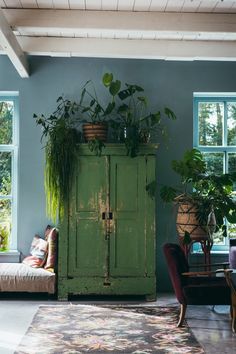 a living room filled with furniture and lots of plants