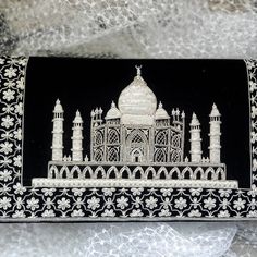 Stunning Taj Mahal, hand embroidered in silver and white colored metallic threads on a lush black velvet evening clutch bag. Taj Mahal is regarded as one of the eight wonders of the world for its architectural beauty. The Taj Mahal dome and minarets are realistically rendered in 3D by a labor intensive technique of embroidering over layers and layers of underlying floss. Very few embroiderers are accomplished in this specialized technique. The silver gives a radiance to the Taj Mahal. The marble Traditional Black Clutch For Festivals, Traditional Black Clutch, Traditional Black Embroidered Clutch, Traditional Silver Embroidered Evening Bag, Luxury Silver Embroidered Clutch, Traditional Silver Clutch For Festivals, Traditional Silver Evening Bag For Festive Occasions, Statement Purse, Purse Luxury