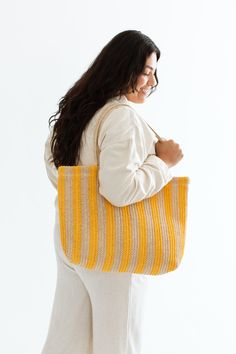 Embrace sunny days with our Lani Woven Beach Bag, perfect for all your summer adventures. This bag features cheerful yellow stripes that add a pop of color to any outfit. Its spacious interior provides ample room for all your beach essentials, while sturdy handles ensure comfortable carrying. Lightweight and stylish, this woven beach bag is a must-have this summer! Bethany Hamilton x CJLA Collection DETAILS Lightweight Inner Compartment Final Sale- No returns or exchanges Length: 20.5" Height: 1 Casual Striped Summer Shoulder Bag, Casual Striped Vacation Bags, Casual Striped Shoulder Bag For Summer, Casual Striped Bags For Vacation, Eco-friendly Yellow Crochet Bag For Vacation, Casual Striped Rectangular Beach Bag, Casual Striped Beach Bag For Vacation, Casual Striped Rectangular Straw Bag, Striped Beach Bag For Everyday Summer Use