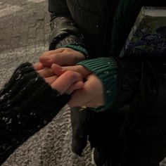 a person holding their hands in the snow