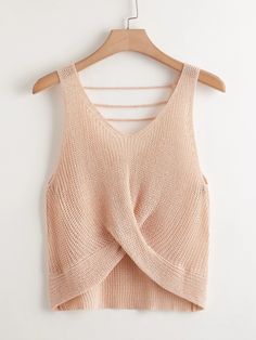 a cropped top hanging on a wooden hanger