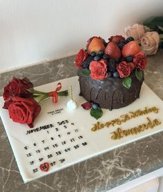 a birthday cake with flowers and berries on it