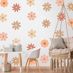 a room with flowers painted on the wall and a hammock in front of it