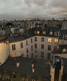 an image of rooftops at dusk with the sun coming through the windows and buildings in the foreground