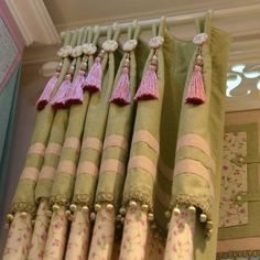 curtains with tassels hanging from them in a room