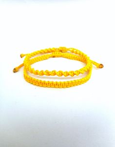 "Yellow macrame bracelets, Twisted and flat knotted Classic macrame friendship bracelets perfect for everyday wear! These handknotted bracelets are made with durable yellow waxed string. They are adjustable and have a sliding knot closure in order to fit a lot of sizes. Due to their waxed threads,the bracelets are very durable and water resistant. Width: 0.4cm / 0.15\" The price is for one bracelet.Or choose the set of 2 to save on shipping! Similar bracelets: https://www.etsy.com/listing/227376 Yellow Friendship Bracelet, Rat Jewellery, Macrame Friendship Bracelets, Yellow Macrame, Movie Outfit, Bts Bracelet, Jewelry Everyday, Sliding Knot Closure, Beach Bracelet