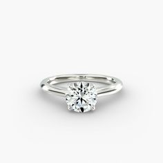 a round brilliant cut diamond engagement ring on a plain white background, with the center setting in