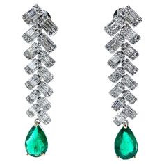 a pair of fashion earrings featuring a pear-shaped emerald as the main stone, with a weight of 3.27 carats and exhibiting a green color. Additionally, there are 328 diamonds serving as side stones. The shape of the diamonds is not specified, but their total carat weight is 7.7 carats. The setting for these earrings is made of 18k white gold, providing a classic and elegant look. Emerald Fashion, Green Fashion, Pear Shape, Pear Shaped, Emerald Green, Green Color, Fashion Earrings, Green Colors, Clip On Earrings