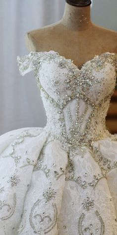 a white wedding dress on a mannequin with beading and sequins