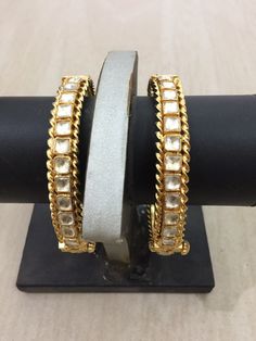 *This is Gold Finish Kundan Bangles pair.Its Perfect for Wedding Occasion as well as Unique and Ethnic Traditional Bangle to gift and Also Bridal wear to match with Wedding Outfits. *Its made from Silver n Copper mix material and 100% Handmade. *Its available in Various Sizes like 2,2.2,2.4,2.6 Etc Its white kundan combination like shown in picture. *Its open able Screwed Bangles Pair. *All Kundan stones set with silver foils handsetting method and long last guarantee of its workmanship.It is Wh Temple Jewelry Bangle With Stone Work For Reception, Traditional Stone Work Bangle For Reception, Traditional Heavy Bangle For Reception, Traditional Bangle For Reception And Festivals, Kundan Bangle With Stone Work For Reception, Traditional Bangle With Tilla For Reception, Stone Work Bracelets For Diwali Reception, Tilla Bangle For Reception And Festivals, Stone Work Bracelets For Reception And Diwali