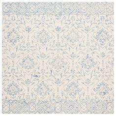 a blue and white rug with an intricate design on the bottom, in front of a white background