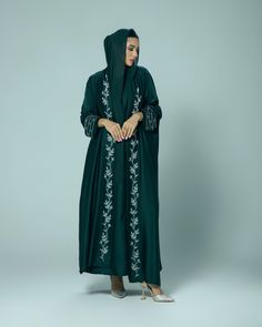 (Estimated delivery for pre-orders: 03/02/25 - 07/02/25. If you require a quicker delivery, please contact us). Giving elegant modesty, the 'Amani' abaya is perfect for all occasions. The satin fabric gracefully flows and is adorned with hand embellished intricate beading on the cuffs and collar. - Slip dress and scarf included. - Dry clean only. - Model is 5'6 wearing size 54. Elegant Hand Embellished Long Sleeve Abaya, Elegant Long Sleeve Hand Embellished Abaya, Elegant Green Embroidered Thobe, Elegant Long Sleeve Abaya With Embroidered Border, Long Silk Abaya For Eid, Silk Long Abaya For Eid, Silk Maxi Abaya For Eid, Embroidered Khimar For Eid, Traditional Silk Abaya For Eid