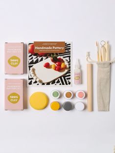 an assortment of crafting supplies on a white surface