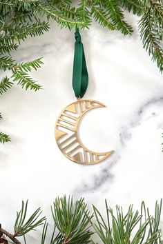 A brass moon christmas tree ornament on a marble background with greenery Celestial Ornaments, Modern Brass Ornaments, Celestial Christmas Ornaments, Moon Christmas Tree Ornaments, Gold Star Ornaments, Lost Wax, Metal Necklaces, Festival Decorations, Metal Jewelry