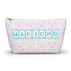 a pink and white cosmetic bag with the word mahjong on it in blue letters