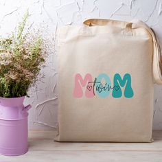 "Elevate the style of every errand with our Retro Canvas Tote Bag designed for Twin Moms on-the-go. This reusable gem is not only a grocery essential but also a thoughtful Mother's Day and birthday gift for the dynamic mom managing her twin babies with flair. * Size:  15\" X 16\" * 100% cotton canvas * Heavy fabric (12 oz/yd² (406.9 g/m * Sewn-in label" Eco-friendly Bag With Letter Print For Gift, Eco-friendly Bags With Letter Print For Gifts, Pink Everyday Bag For Mother's Day, Personalized Canvas Bag For Mother's Day, Mother's Day Bags With Letter Print, Pink Canvas Gift Bag For Mother's Day, Eco-friendly Gift Bag For Mother's Day, Beige Gift Bag For Mother's Day, Mother's Day Gift Bag In Beige