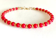 "Dainty beaded red bamboo coral bracelet with gold vermeil spacers and gold fill clasp.  Genuine 3-4mm smooth red bamboo coral rounds alternate with 2x3mm 24k gold vermeil spacers. Closes with 14k gold fill spring ring clasp and 1\" extension. Also available in .925 sterling silver.  When selecting size please add 1/2\" to actual wrist measurement for a comfortable fit." Gold Red Coral Bracelets As Gift, Gold Bracelets With Red Coral As Gift, Gold Red Coral Bracelets For Gifts, Gold Red Coral Bracelet As A Gift, Gold Red Coral Bracelet For Gift, Elegant Red Bracelets With Gold Beads, Red Coral Jewellery, Red Bamboo, Armband Gold