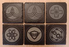 four square coasters with different symbols on them