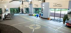 an indoor basketball court is shown in the middle of a room with lots of windows