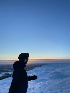 a person standing on top of a snow covered slope