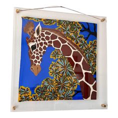 a giraffe painting hanging on the wall