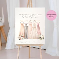 an easel with three brides dresses on it