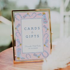 a card and gift box sitting on top of a wooden table