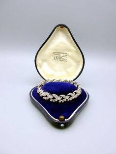 Gorgeous vintage Ladies 14k white gold and all diamond bracelet. It measures 7" long by 3/8" wide and looks delicate yet substantial at the same time. It has a locking bar safety clip and is marked 14k on the underneath of the clasp as shown. The antique boxes shown are for display purposes only and are not included in this listing. Luxury Vintage Bracelets With Diamond Hour Markers, Vintage White Gold Diamond Bracelet With Brilliant Cut, Vintage Diamond Bracelet With Brilliant Cut For Formal Occasions, Vintage Diamond Tennis Bracelet With Single Cut Diamonds, Vintage Brilliant Cut Tennis Bracelet For Wedding, Vintage Platinum Diamond Bracelet With Single Cut Diamonds, Vintage Diamond Bracelet For Anniversary, Vintage Brilliant Cut Diamond Bracelet For Wedding, Vintage White Gold Tennis Bracelet With Diamond Accents