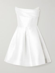 a white dress with a bow at the waist