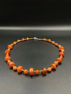 A beautiful collection of very old ancient Carnelian Beads Himalayan beads The origin of this beads are from Tibet . very unique shape of the carnelian some brass beads are used as spacers the age of this beads are more than 1000 years old we provide fast and free shipping service world wide Traditional Orange Gemstone Beaded Necklace, Traditional Orange Beaded Necklace With Gemstones, Orange Agate Necklace With Polished Beads, Carnelian Jewelry With Colorful Round Beads, Carnelian Jewelry With Colorful Beads, Traditional Orange Beads With Natural Stones, Handmade Carnelian Beads For Jewelry Making, Polished Amber Beads For Jewelry Making, Amber Round Beads For Jewelry Making