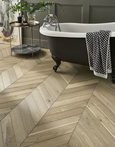 a bath tub sitting on top of a wooden floor