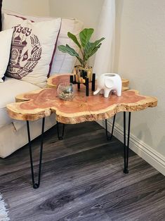 a wooden table with hairpin legs and a potted plant sitting on top of it