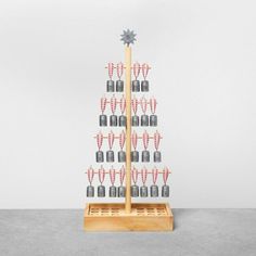 a wooden stand with several bottles on it and a star hanging from the top in front of them