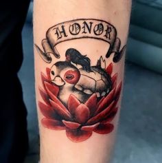 a tattoo on the leg of a person with a ribbon around it that says honor