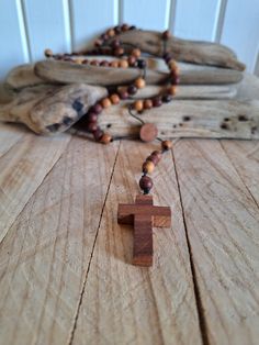 Wooden rosaries , Exquisite Handcrafted Wooden Rosary , Handmade Natural Wood  Beads Rosary , Rosary Necklace , Spiritual Gift  Prayer Beads This exquisite rosary is meticulously crafted from various natural woods, featuring a beautifully hand-carved wooden cross and 8mm wooden beads, all made by hand. The total length of the rosary is approximately 47 cm (18.5 inches). Each bead and the cross are carefully handcrafted, ensuring that every piece is unique. Perfect for personal devotion or as a m Spiritual Beaded Rosary As Gift, Beaded Cross Rosary For Meditation, Meditation Cross-shaped Beaded Rosary, Beaded Brown Rosary Gift, Spiritual Wooden Beaded Jewelry For Gifts, Spiritual Wooden Beads Jewelry As Gift, Spiritual Wooden Beaded Jewelry As Gifts, Spiritual Wooden Beaded Necklaces As Gift, Bohemian Beaded Rosary For Healing