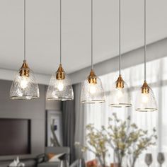 five lights hanging from a ceiling in a living room