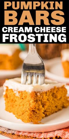 a slice of pumpkin bars with cream cheese frosting is on a white plate and has a fork in it